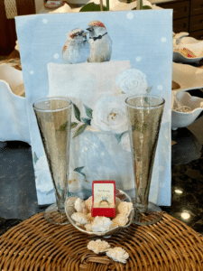 Gold Champagne flutes and a sweet tea towel that has two love birds on it!