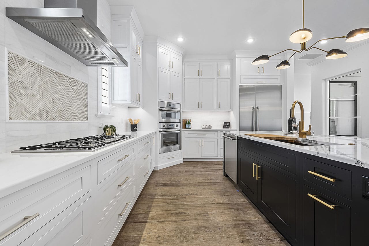 Image of timeless, white kitchen with a black center island.